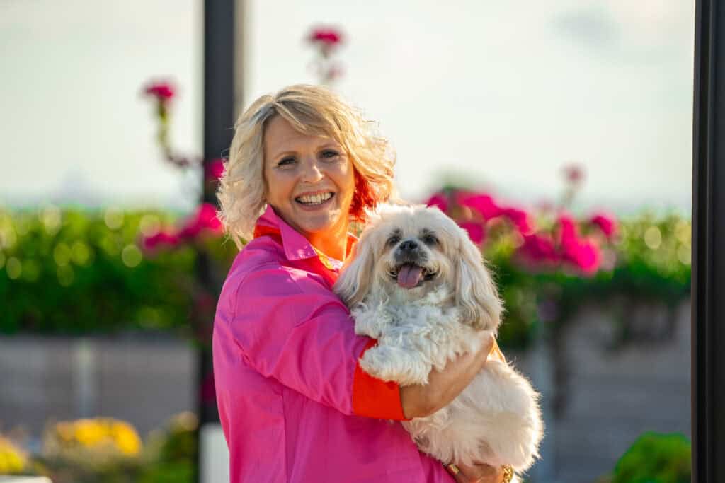 Senior woman holding her dog at Oak Tree Retirement Village