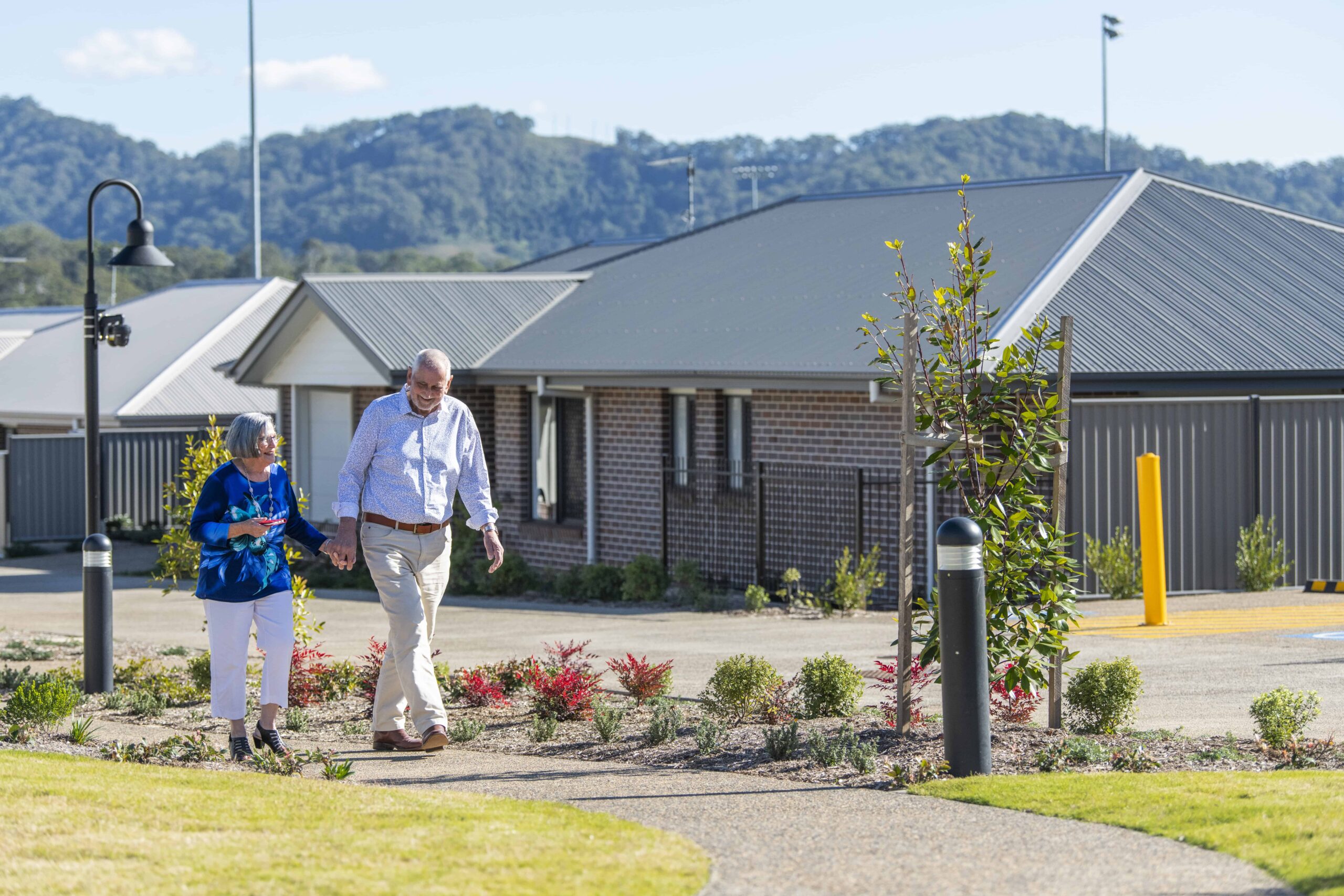 A senior couple enjoying a walk through coffs harbour retirement village