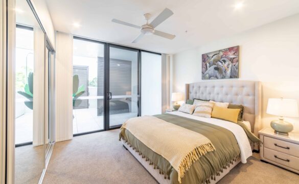 Bright bedroom with built in storage and patio doors in one of our Oak Tree Retirement village apartments.