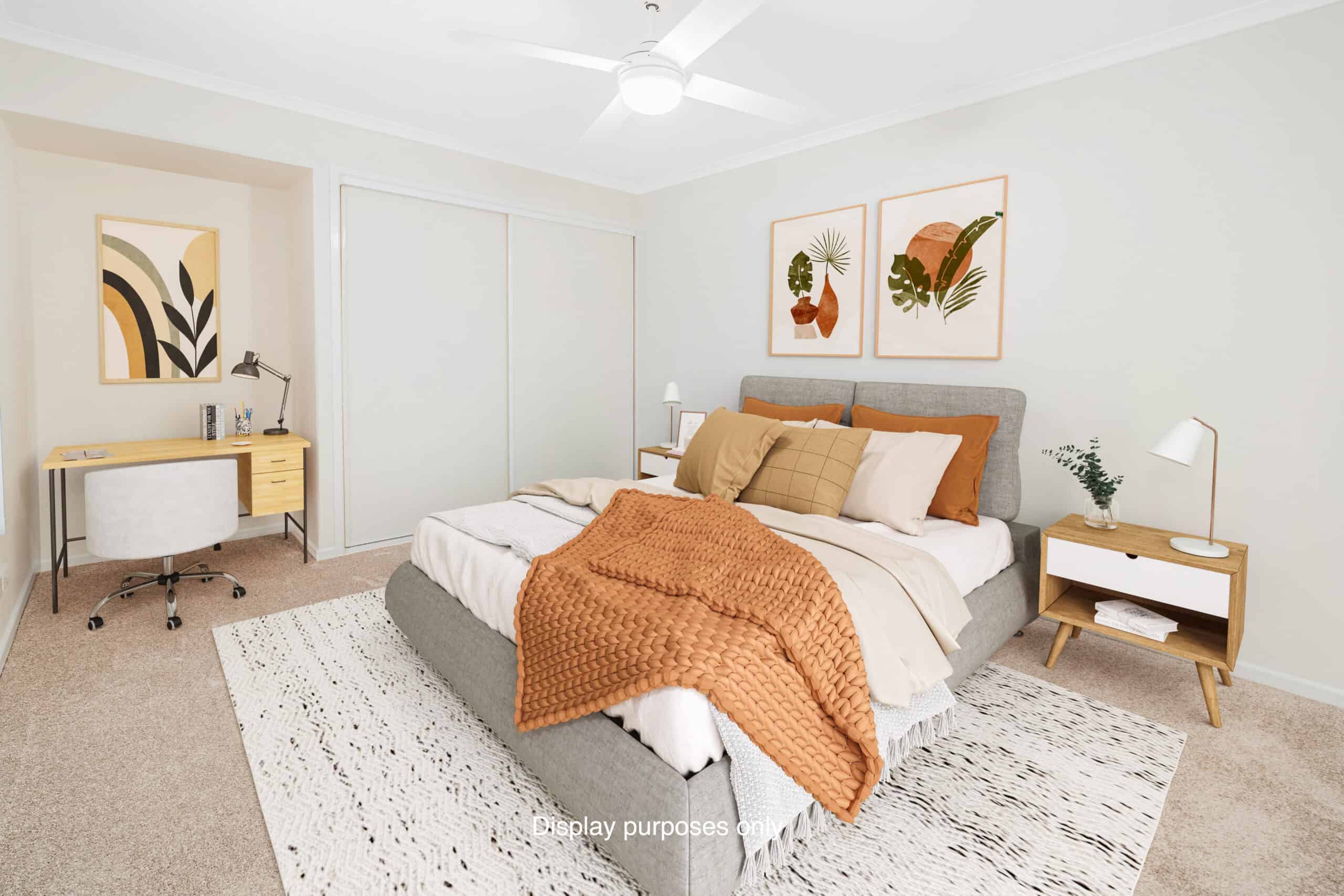 Large, bright bedroom with bed, desk and built in wardrobes in one of our Oak Tree Goodna Retirement Village properties.