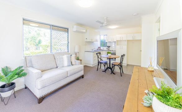 Living room in Goodna Villa 62 featuring a couch, table, and television