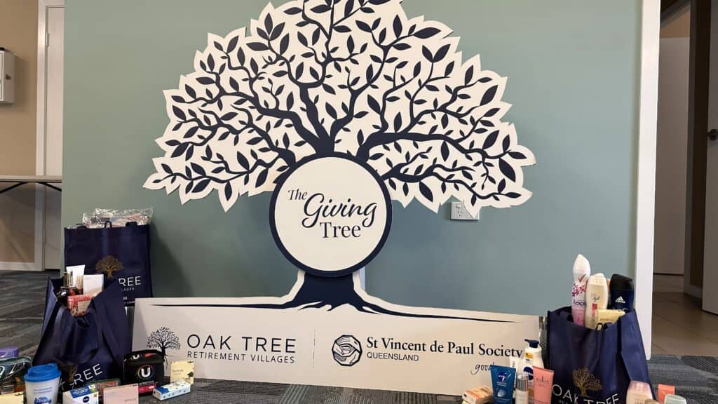 A photograph of the signage and donations from the collaboration between Oak Tree Retirement Villages and St Vincent de Paul to help those in need this holiday season.