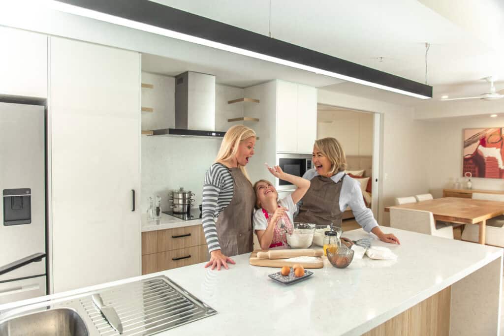 Three generations of women celebrating mothers day in the kitchen of one of our retirement homes.
