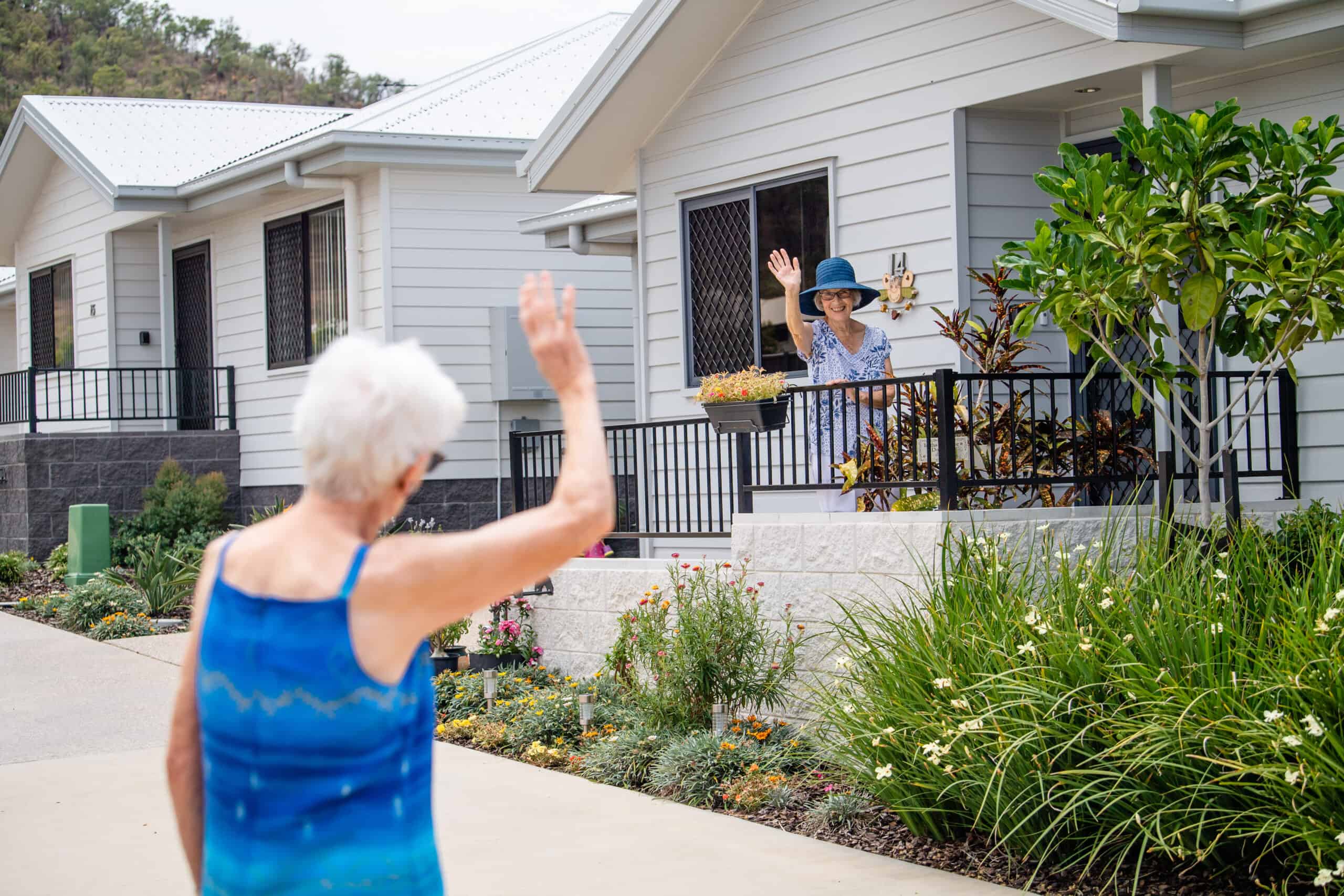 Single senior women waving at each other in one of our Retirement Villages