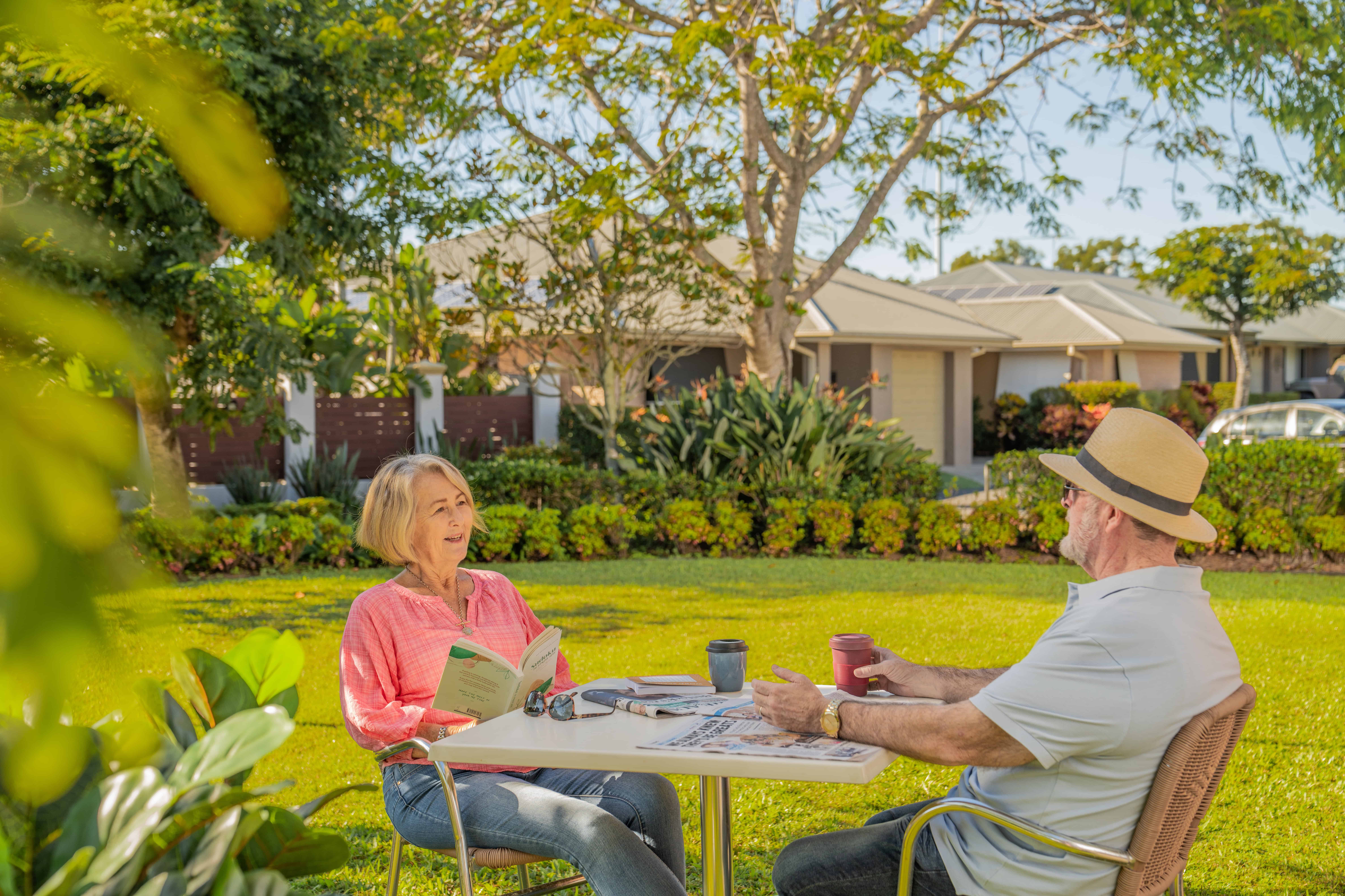 Senior couple enjoying sitting outside in our retirement community