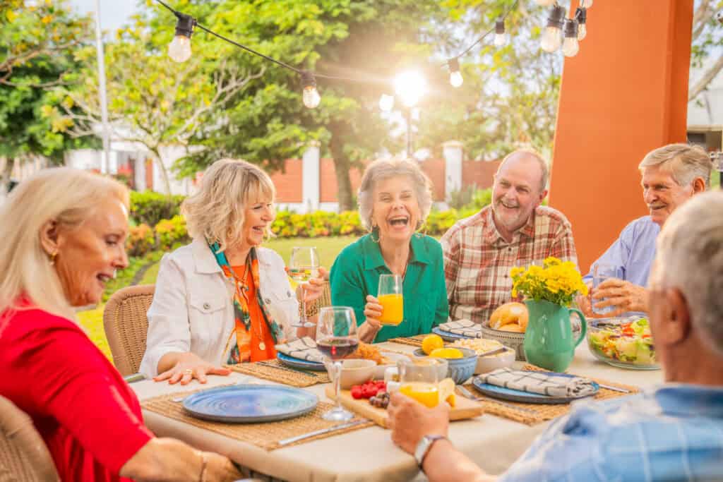Senior friends embracing getting older together, enjoying retirement living at Oak Tree