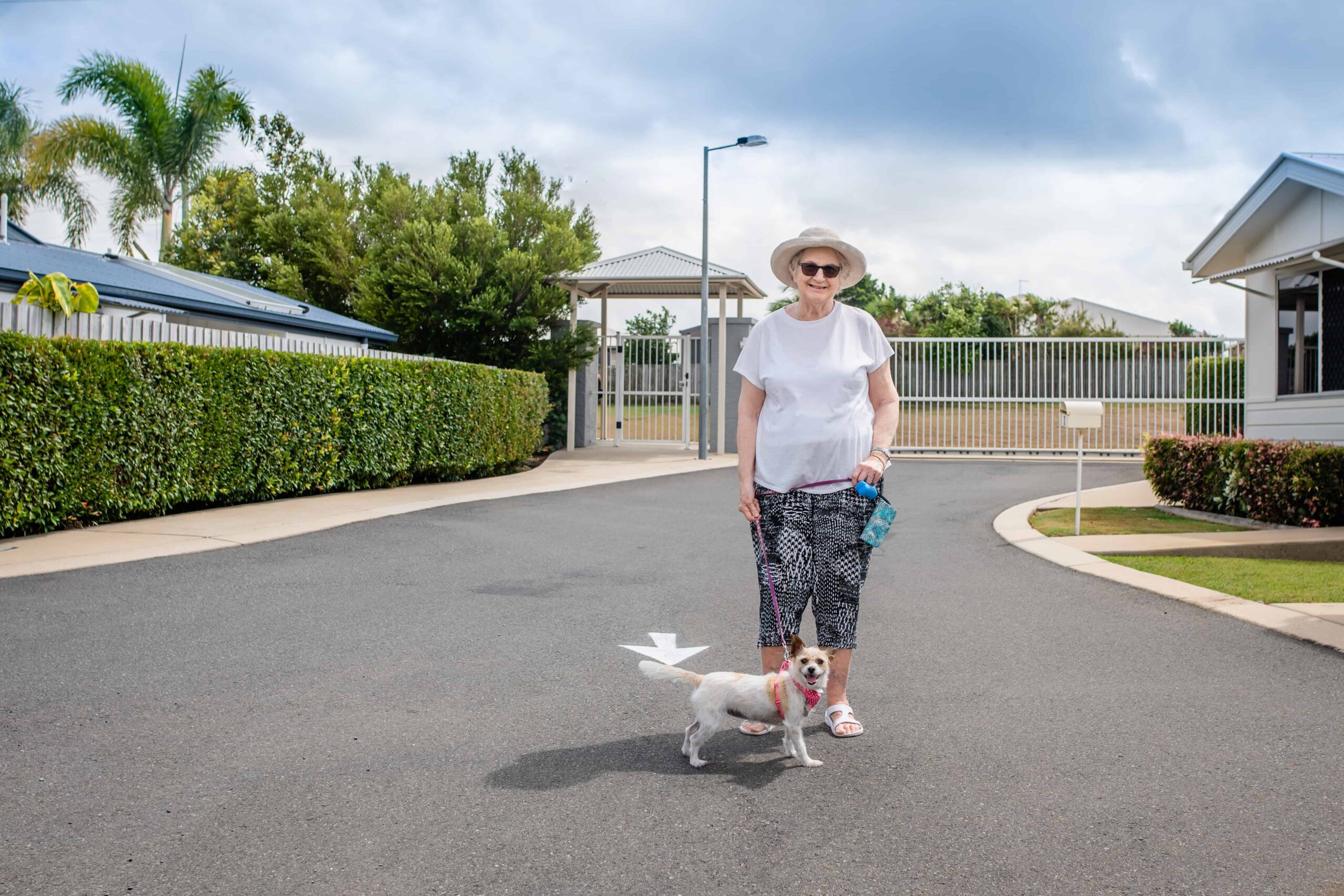 Senior lady taking her dog for a walk in our gated community in Yeppoon