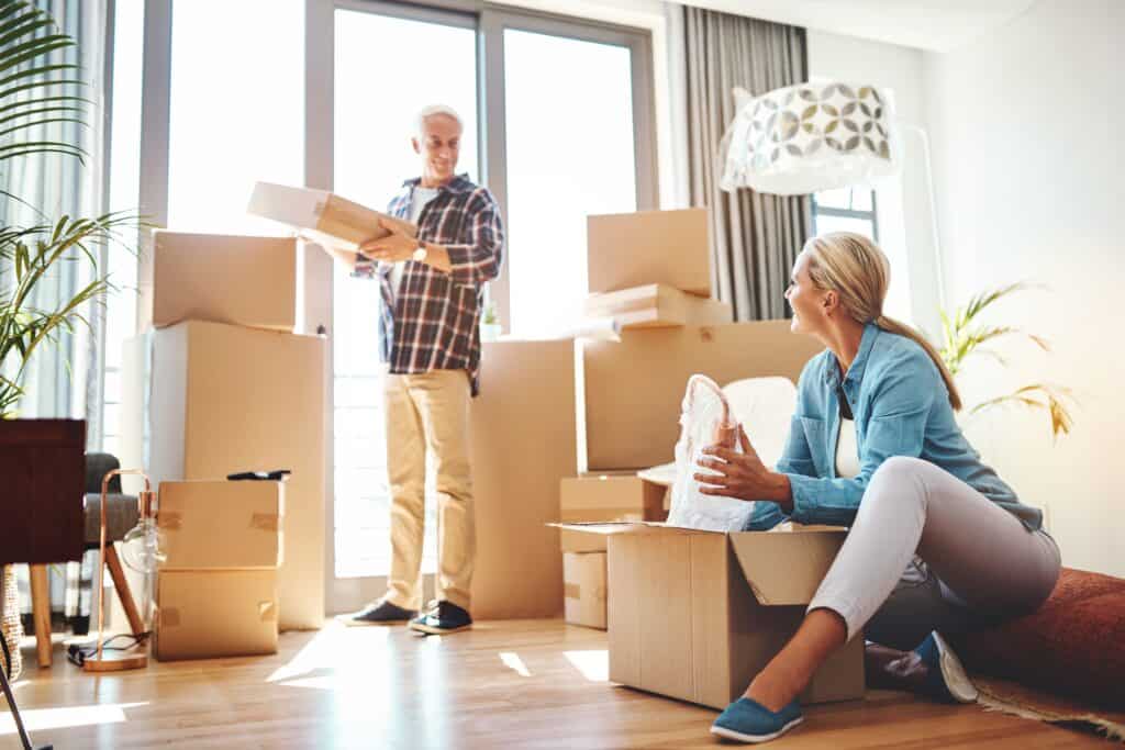 Man and woman packing boxes downsizing their home