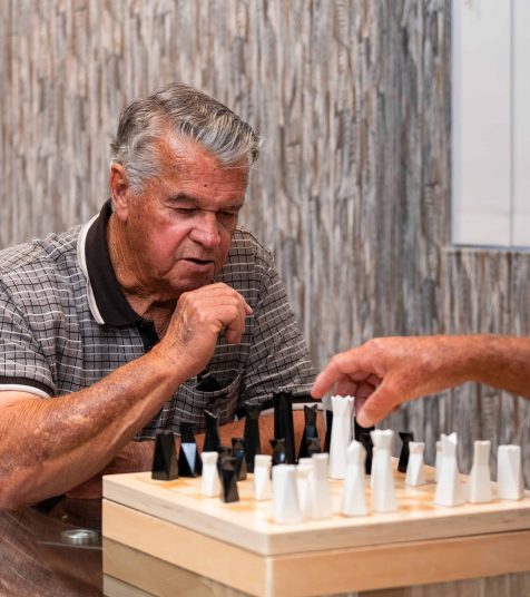 Senior men playing a game of chess at our Oak Tree Retirement Village in Jesmond