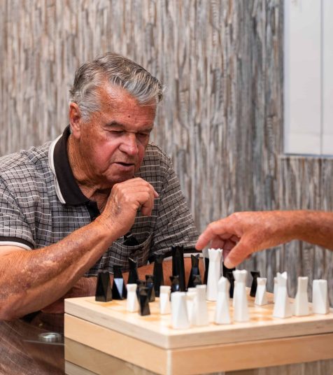 Senior men playing a game of chess at our Oak Tree Retirement Village in Jesmond