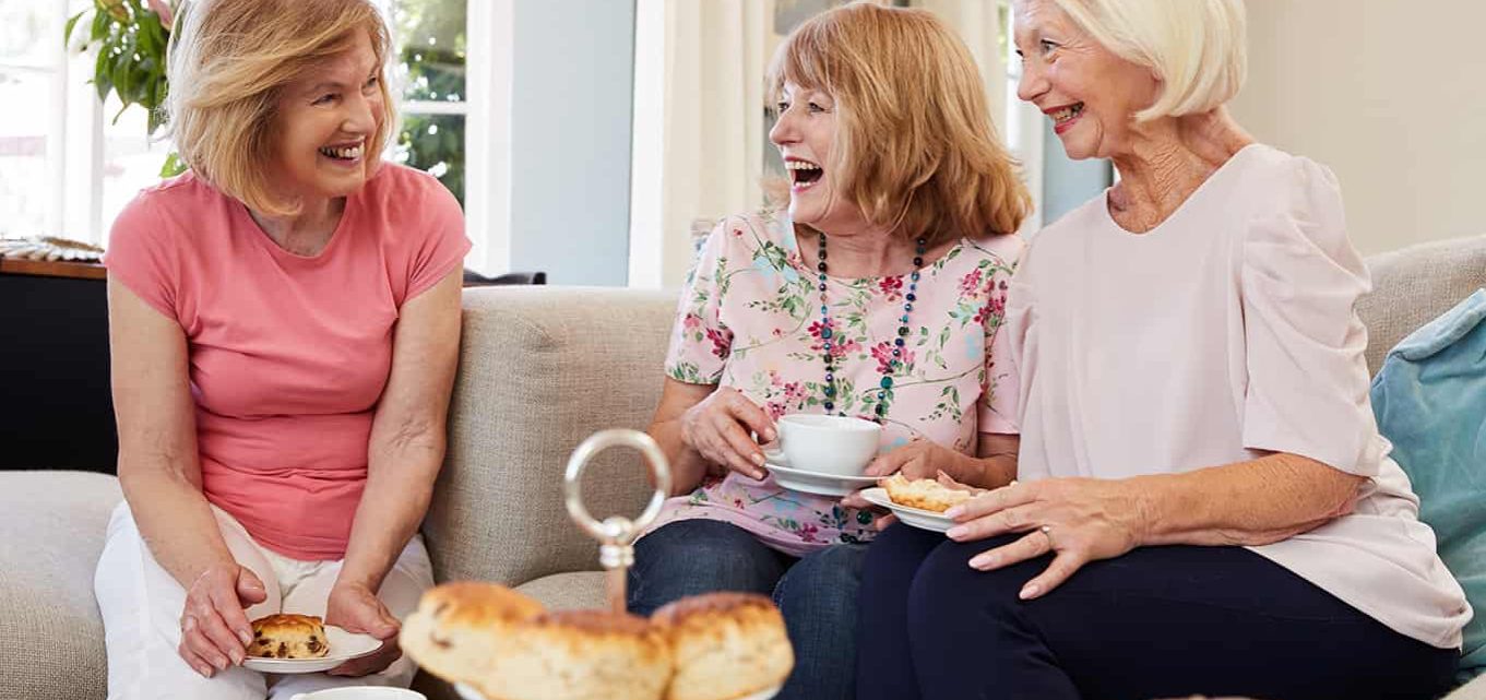 Senior Female Friends Enjoying Afternoon Tea At Home Together