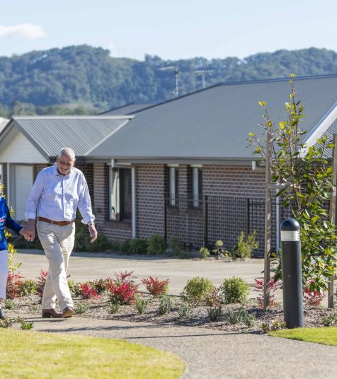 A senior couple enjoying a walk through coffs harbour retirement village