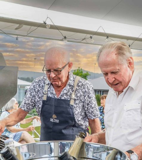 Men enjoying drinks and a BBQ at our Coffs Harbour retirement village.
