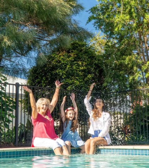 A family enjoying the pool at one of our Oak Tree Retirement Village Brisbane