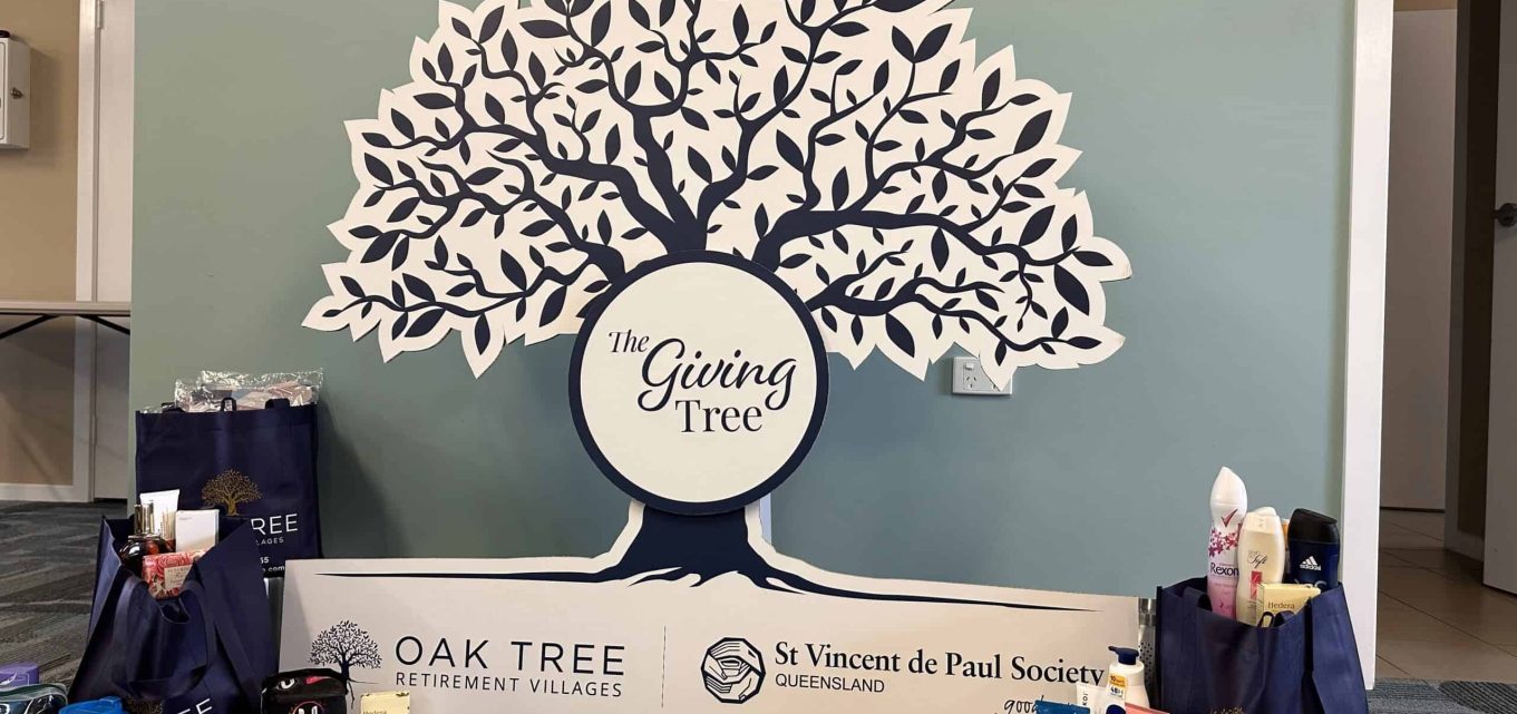 A photograph of the signage and donations from the collaboration between Oak Tree Retirement Villages and St Vincent de Paul to help those in need this holiday season.