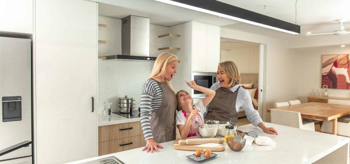Three generations of women celebrating mothers day in the kitchen of one of our retirement homes.