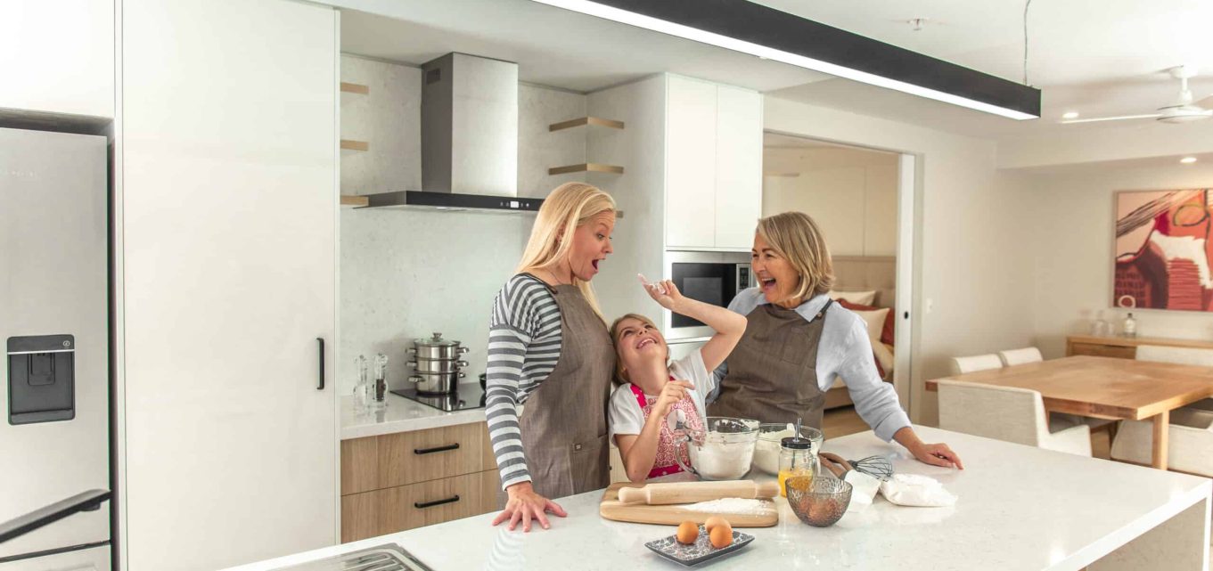Three generations of women celebrating mothers day in the kitchen of one of our retirement homes.