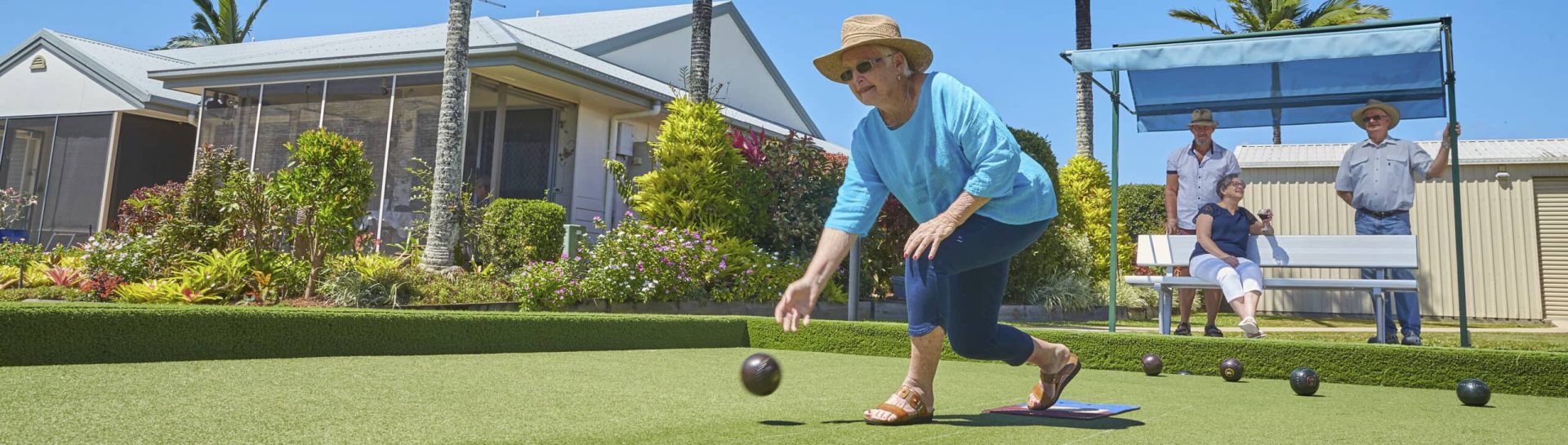Resident playing lawn bowls at retirement village