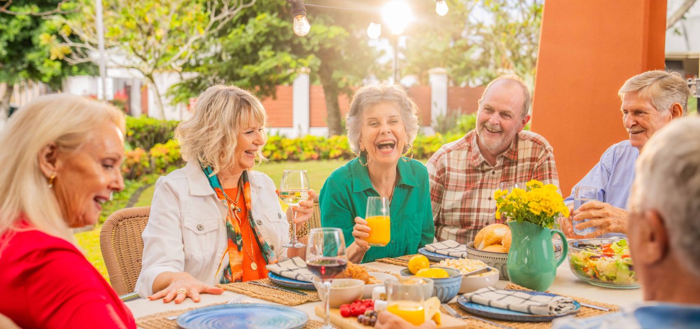 Senior friends embracing getting older together, enjoying retirement living at Oak Tree