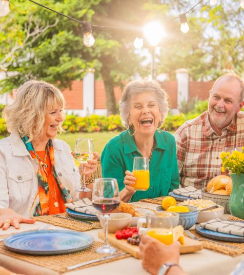 A group of seniors in Yeppoon enjoying a meal together in and Oak Tree Retirement Village