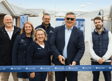 Oak Tree Group team doing a ribbon cutting ceremony.