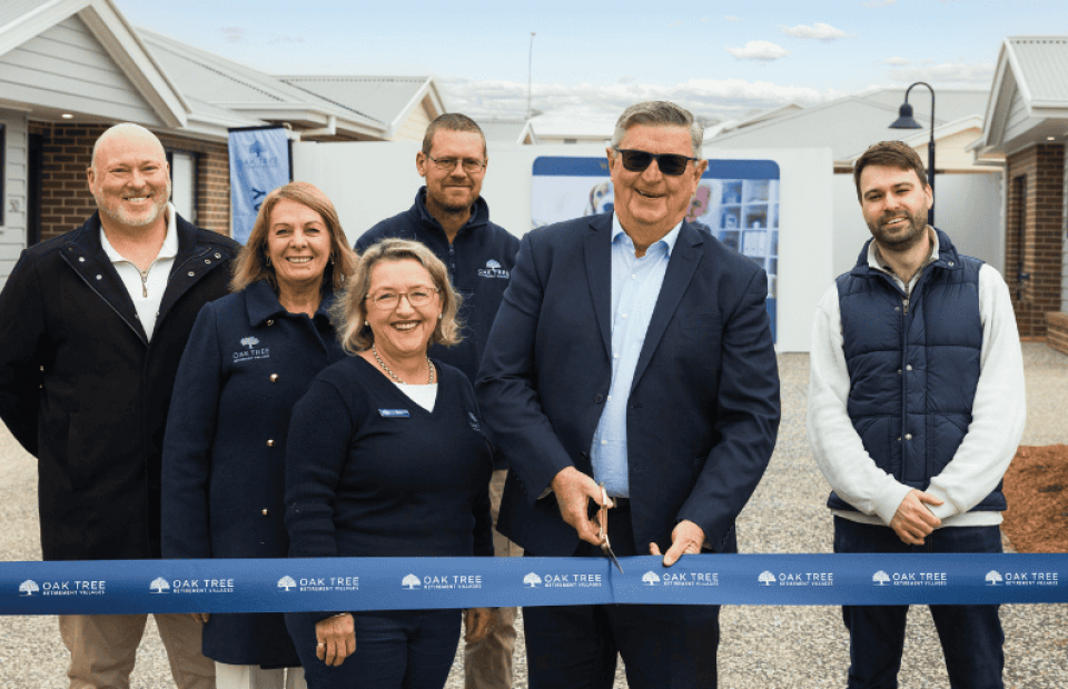 Oak Tree Group team doing a ribbon cutting ceremony.
