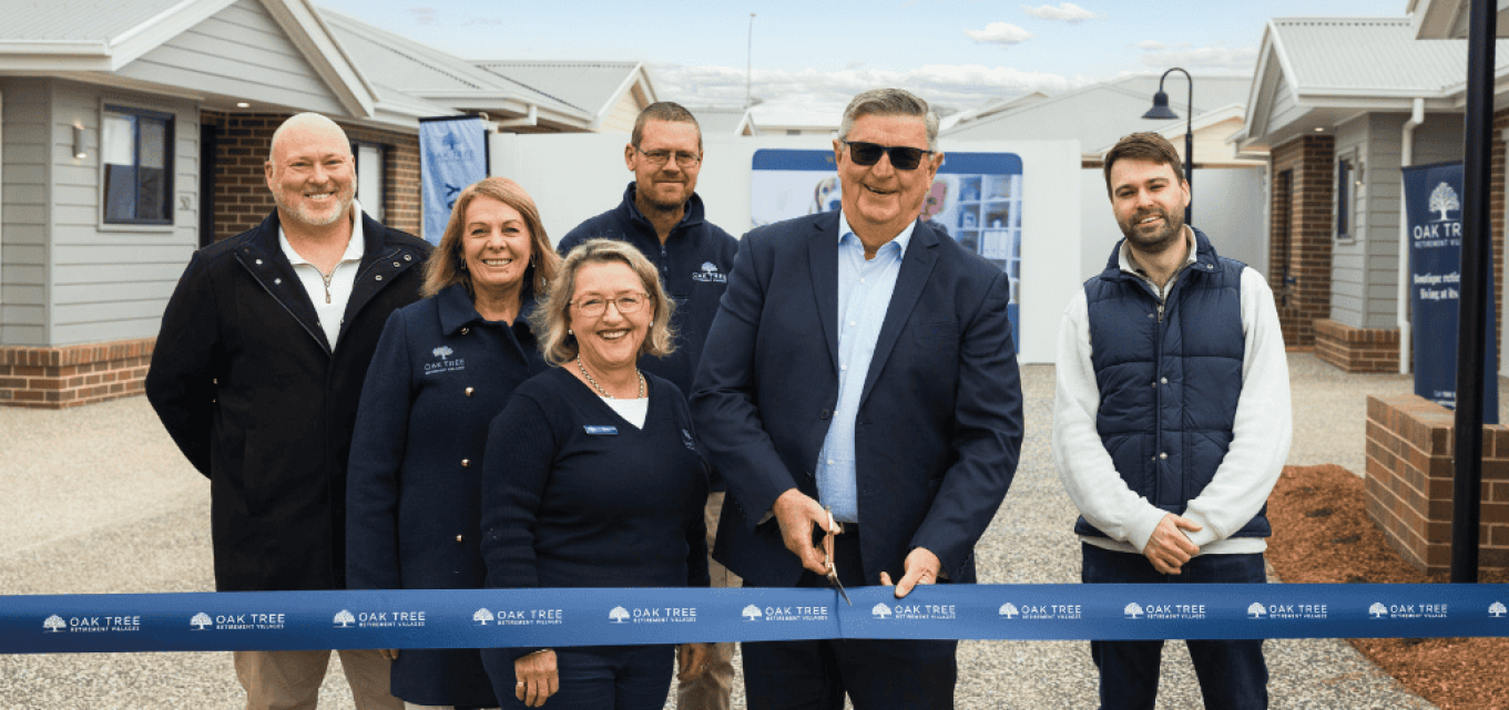 Oak Tree Group team doing a ribbon cutting ceremony.