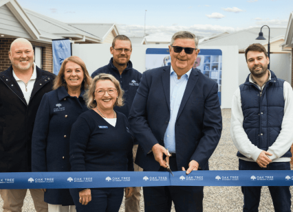 Oak Tree Group team doing a ribbon cutting ceremony.