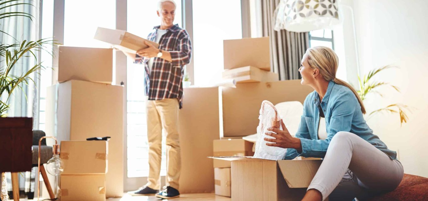 Man and woman packing boxes downsizing their home