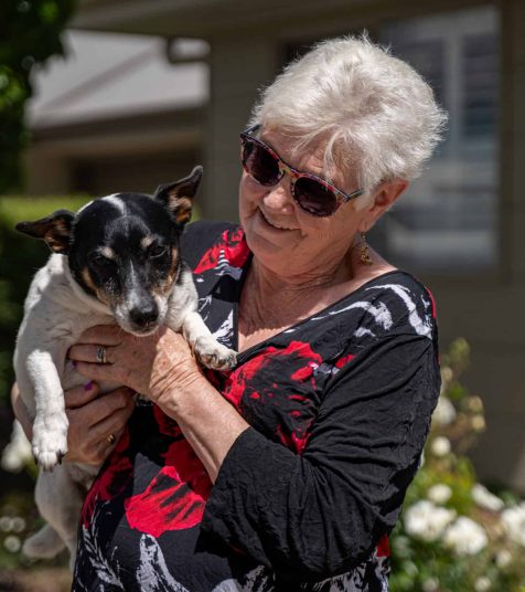 Senior woman taking her dog for a walk in one of our Oak Tree Retirement Villages