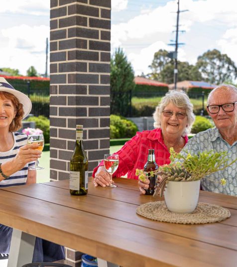 Senior friends enjoying a drink at Oak Tree Retirement Village
