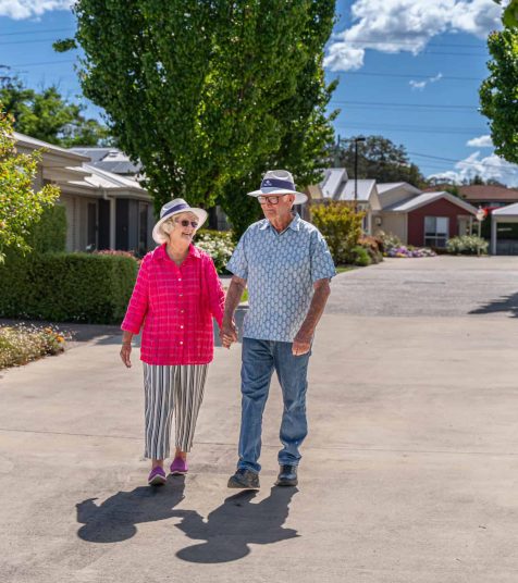 Senior couple out for a walk in their Oak Tree Retirement Village
