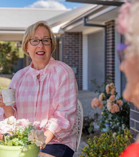 Senior woman in conversation with her friend at Oak Tree Retirement Village
